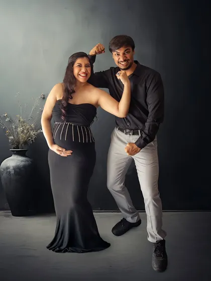 A fun shot showing the couple's strength and humor. This pose is full of personality and captures the fun side of their relationship.