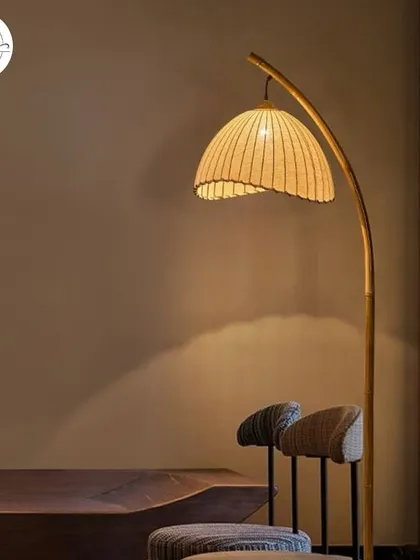 A bamboo and fabric lamp that provides a soft, diffused light, perfect for creating a calm and relaxing atmosphere.