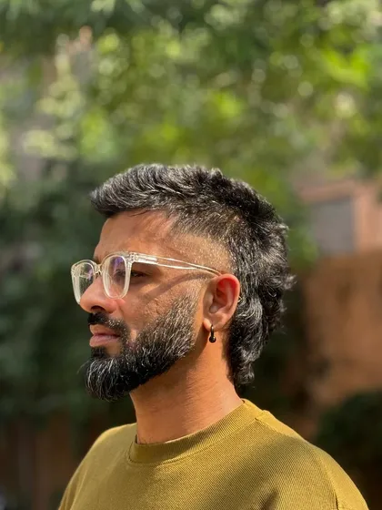 A side profile of the modern mullet, showcasing the texture and flow from the shorter front to the longer back.