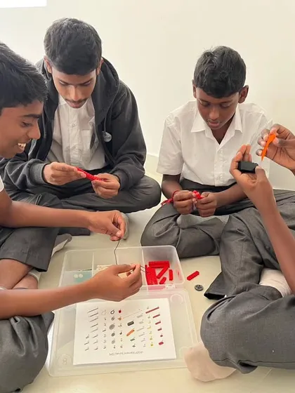 Students from Sadhu Vaswani International School are all smiles as they collaborate on their build during our in-school workshop.