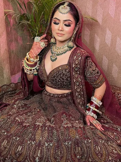 Another angle of the beautiful bride in the maroon lehenga, highlighting the detailed craftsmanship.