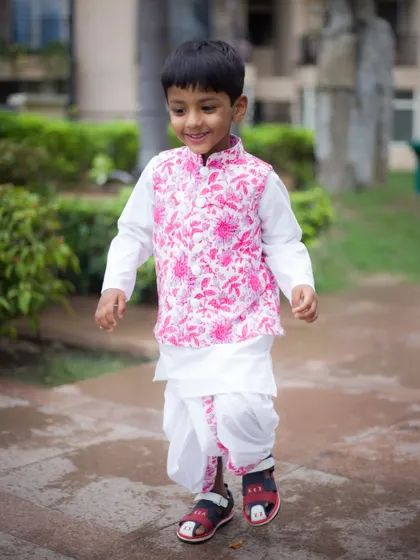 Capturing the pure joy of childhood during a birthday photoshoot. This little one looks so happy and confident in his traditional attire for his special day.