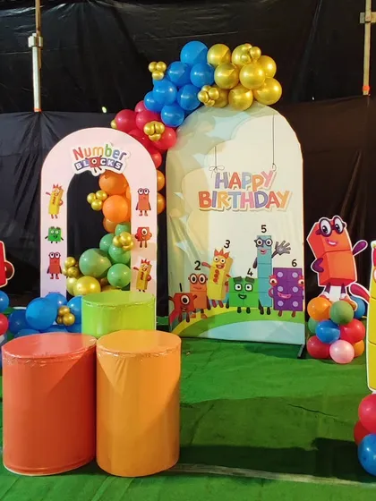 A colorful and educational "Numberblocks" themed party. This setup includes custom backdrops and character cutouts of the popular Numberblocks figures, surrounded by bright balloon arrangements.