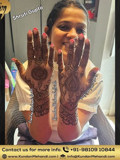 A happy client showing her elegant and simple mehndi design, perfect for someone who wants a less heavy look.