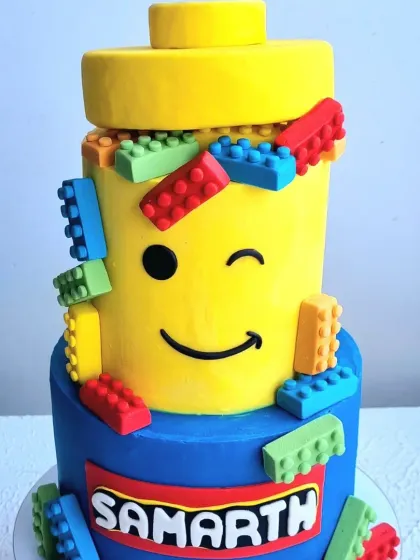 A slightly different angle of the Lego cake, showing the winking face and colorful bricks.