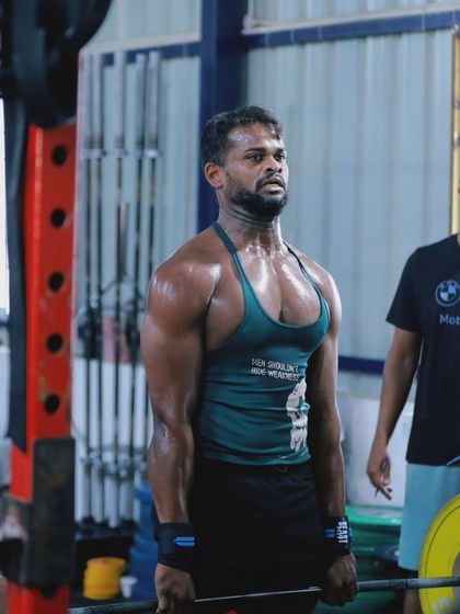 An athlete prepares for a heavy deadlift, a foundational movement for building raw strength.