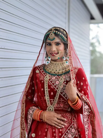 A beautiful North Indian bridal look in a red lehenga, created by one of my talented students.