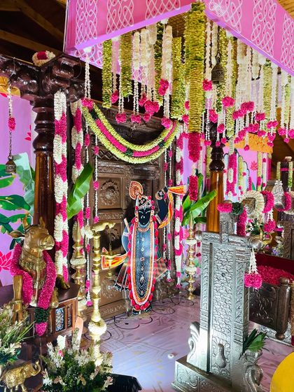 Another angle of the intricate naming ceremony decor. The layers of flowers, props, and artwork come together to create a rich and immersive experience for the family and guests.