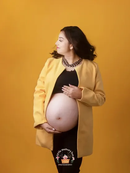 The styling with the statement necklace adds another layer to this contemporary maternity portrait, showing that you can be pregnant and fashionable.