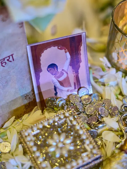 A close-up of the decor, showing a miniature painting, scattered coins, and a jeweled box, all contributing to the rich, historical theme.