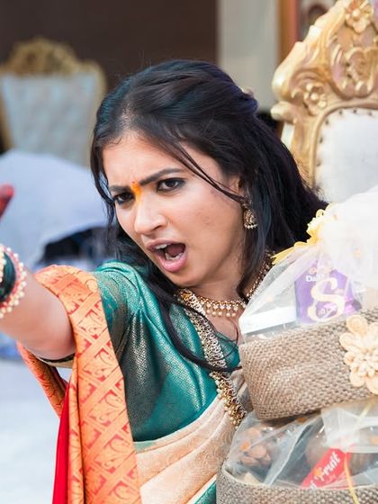 A bride's fun and dramatic expression during a wedding game.