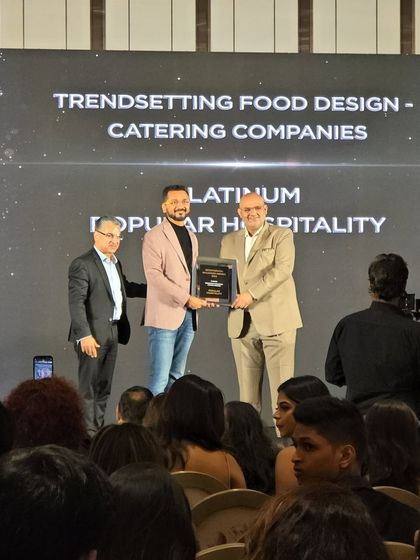 Posing with our Platinum Award for Trendsetting Food Design. This is a recognition of our commitment to pushing the boundaries of culinary artistry.