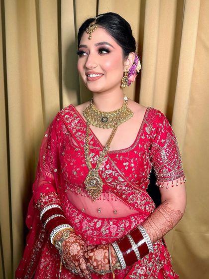 A smiling portrait of my enchanting bride. Her soft makeup look with a winged liner and pink lips perfectly matches her vibrant lehenga.
