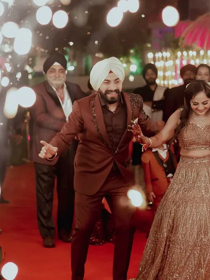 The celebration begins the moment you walk in. This shot captures the pure energy and happiness of a couple making their entrance at their engagement party.
