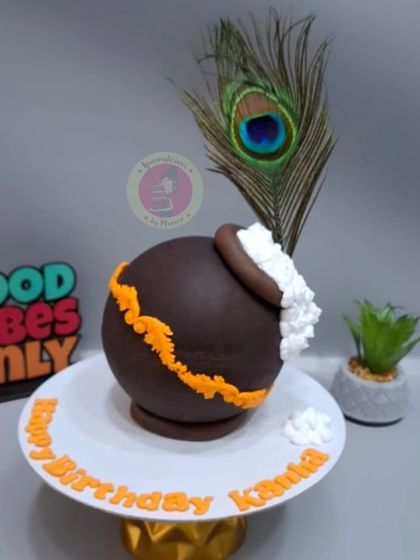 A Janmashtami-themed piñata cake shaped like a matki, filled with chocolates for kids to enjoy.