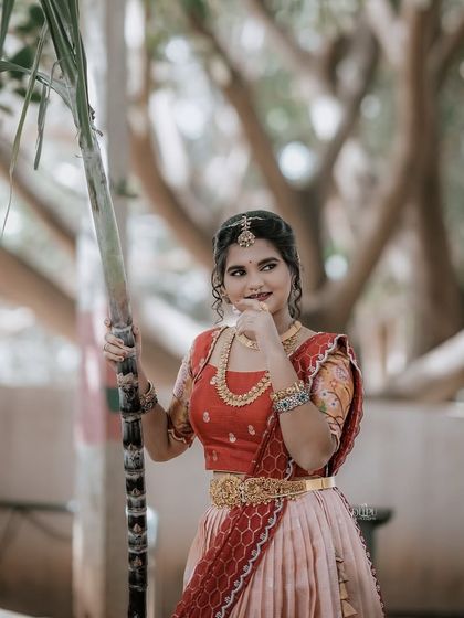 For the Makara Sankranthi festival, I designed this exquisite Zari Kota lehenga for my client. The peach skirt with a traditional border is paired with a red brocade blouse, creating a vision of grace and tradition.