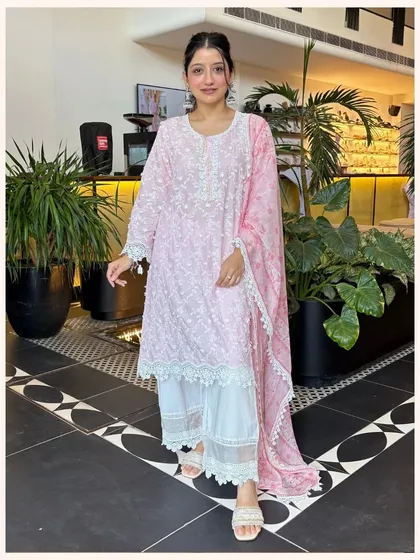This fresh pink and white kurta set is perfect for daytime wear. The intricate embroidery and lace detailing on the pants make it a standout piece.