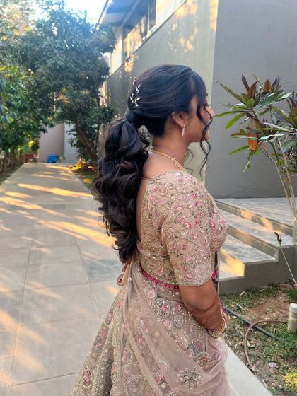A side profile of the bride with her low ponytail, a chic and comfortable style for a long evening of celebration.