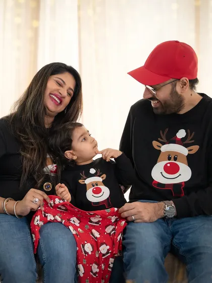 This family in matching reindeer sweaters perfectly captures the fun and playful side of the holidays. These sessions are all about creating joyful memories.