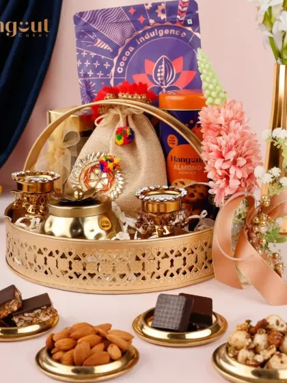 The Vasodaya hamper is where heritage meets indulgence. This arrangement features traditional diyas and potlis alongside modern gourmet treats, all presented in a beautiful golden tray.