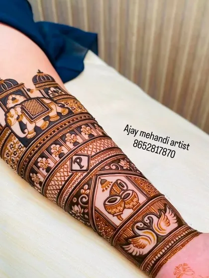 The finished look of the arm design, featuring an elephant in a royal procession, swans, and ceremonial drums.