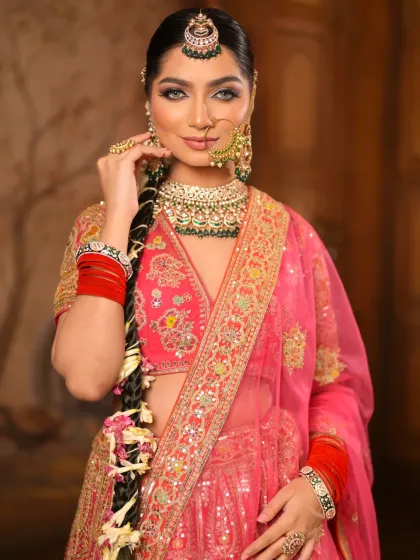 This portrait showcases the complete look, from the detailed eye makeup and nude lips to the traditional nose ring and maang tikka. It's a modern take on a classic bridal style.