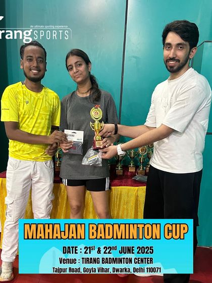 The mixed doubles winners posing with their trophy. These events bring the entire badminton community together.