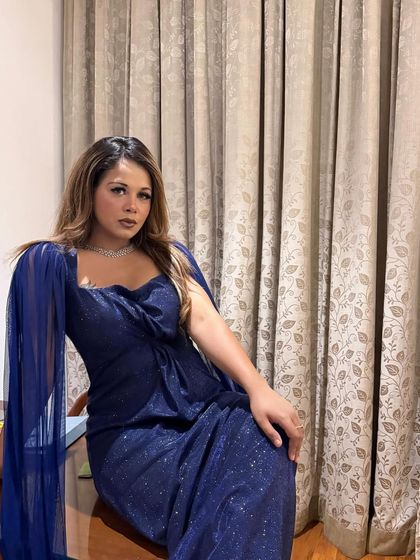 A quiet moment of reflection before the spotlight finds me. This shimmering blue gown was my choice for a glamorous cocktail night.