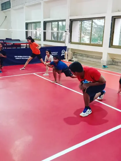Young players in a ready stance during a fitness drill. This fundamental position is crucial for explosive movement and quick reactions during a match.