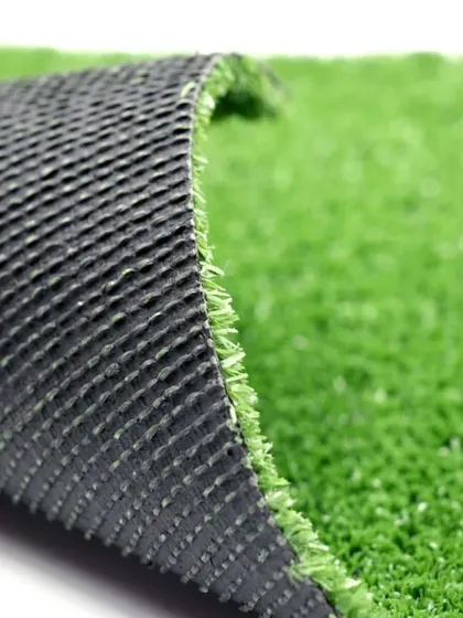 A view of the turf from the side, showing the dense blades attached to the flexible yet strong backing. This construction is what makes it so durable.
