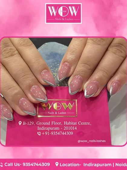 These almond-shaped extensions in a shimmering mauve are accented with a fine silver line along the cuticle. This design is a perfect example of subtle yet impactful nail art.