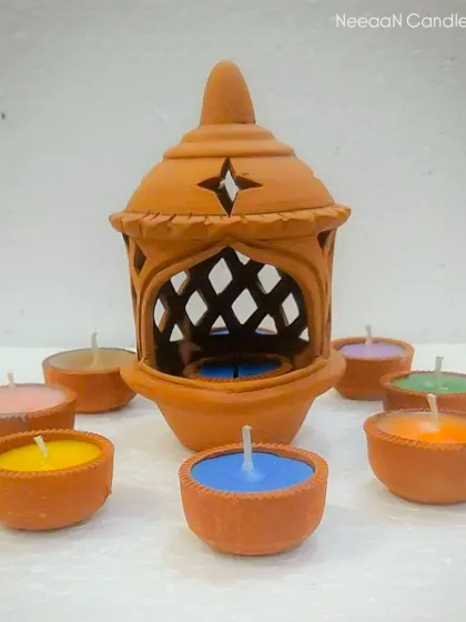 Add a touch of tradition with a pop of color. This handcrafted clay lantern comes with vibrant terracotta tealights.