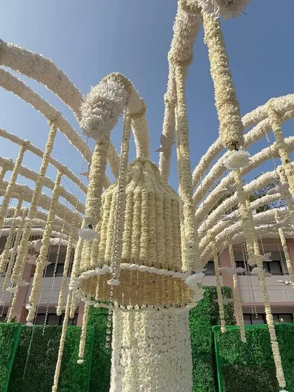 A 'Kalpavriksha' or wish-fulfilling tree made entirely of white flowers, a unique and symbolic centerpiece for the wedding decor.