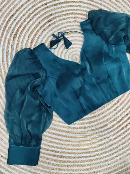 The teal blue organza blouse, a perfect statement piece.