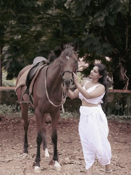 A female warrior concept shoot. These images showcase dynamic action poses, including mid-air shots with a bow and arrow, and serene moments with a horse, all set against a dramatic, smoky backdrop.