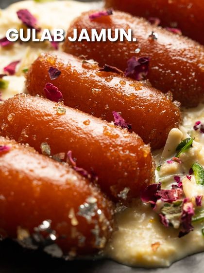 My Gulab Jamun is served in a creamy rabri and garnished with rose petals, a truly royal treat.