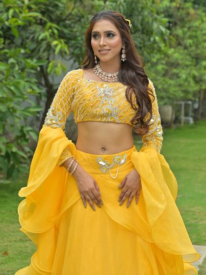 Another shot of the yellow Haldi lehenga, highlighting the embellished blouse and modern silhouette.
