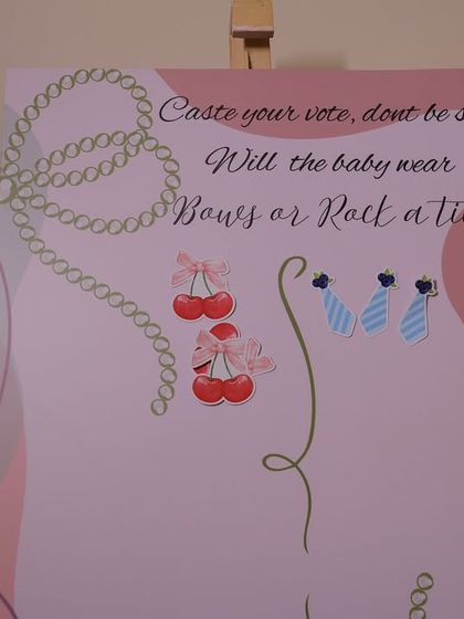 Guests have cast their votes on the "Bows or Rock a Tie" board. This interactive element is always a fun conversation starter at baby showers.