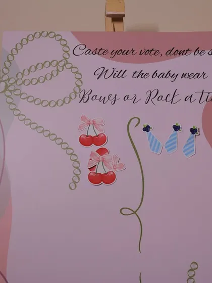 Guests have cast their votes on the "Bows or Rock a Tie" board. This interactive element is always a fun conversation starter at baby showers.