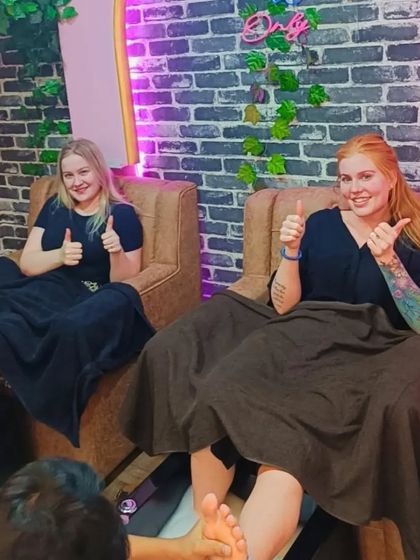 Happy clients enjoying a relaxing pedicure session together in our comfortable salon chairs.