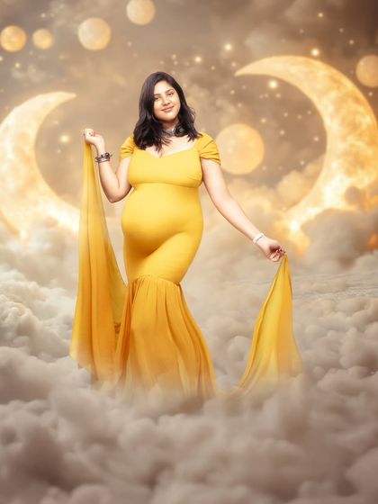 Walking among the clouds, wrapped in golden dreams. This mom-to-be is glowing like the moon itself in this surreal, dreamlike portrait.