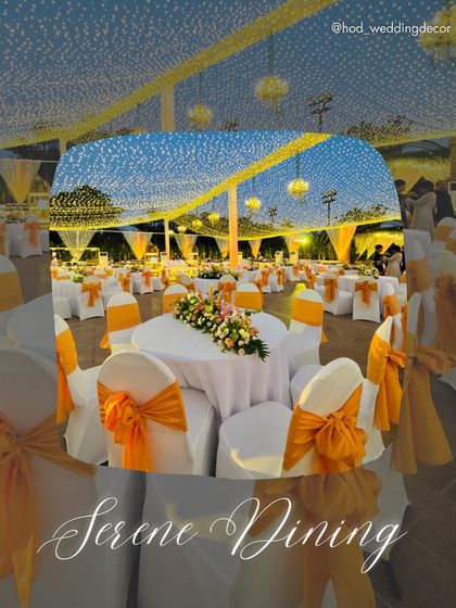 A "Serene Dining" setup under a canopy of lights, with tables dressed in white and accented with orange bows, creating a warm and festive look.
