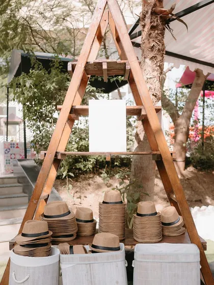 A hat station for a sunny outdoor event. A practical and stylish party favor that guests can use right away.