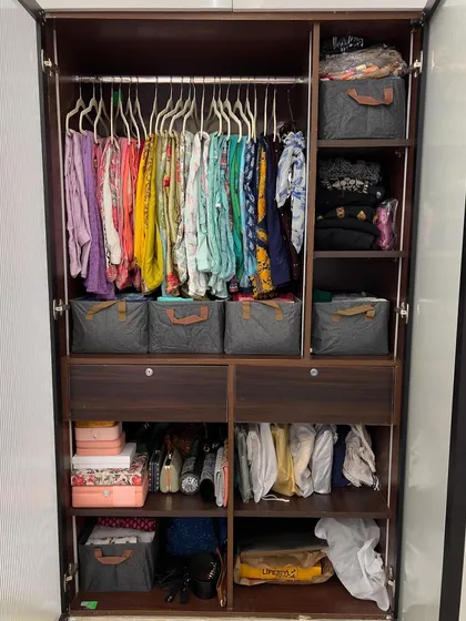 This wardrobe for Indian wear showcases how to organize dupattas on hangers and use baskets for other items, all within a beautiful wooden closet.