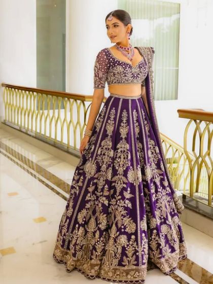 A rich, royal purple lehenga with intricate silver embroidery. This is a bold and unique color choice for a bride who wants to stand out.