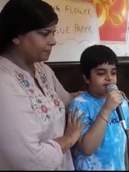 An instructor encourages a young boy as he sings, providing a supportive environment for him to find his voice and overcome stage fright.