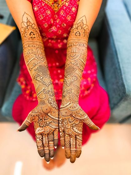 A full bridal set with intricate patterns covering the hands and arms completely.