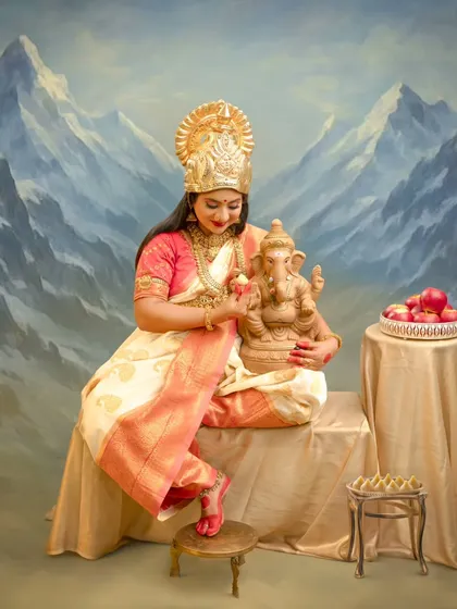 Set against the majestic backdrop of the Himalayas, this portrait symbolizes the divine connection between motherhood and nature's grandeur, with Lord Ganesha as a blessed companion.
