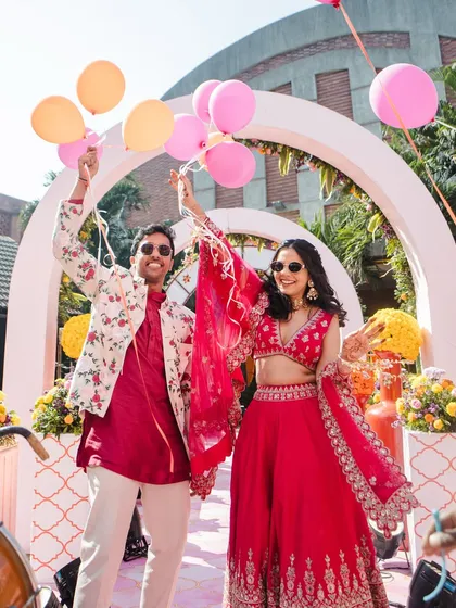 The couple's grand entrance with balloons. A picture-perfect moment from a fun-filled pre-wedding carnival.