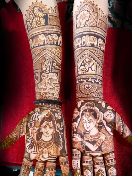 This design features a stunning portrait of Lord Shiva on one palm and Goddess Parvati on the other, with their initials "AK" and mantras on the arms.